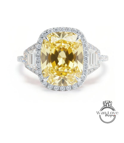 A large yellow diamond ring with a halo of smaller diamonds around the center stone.