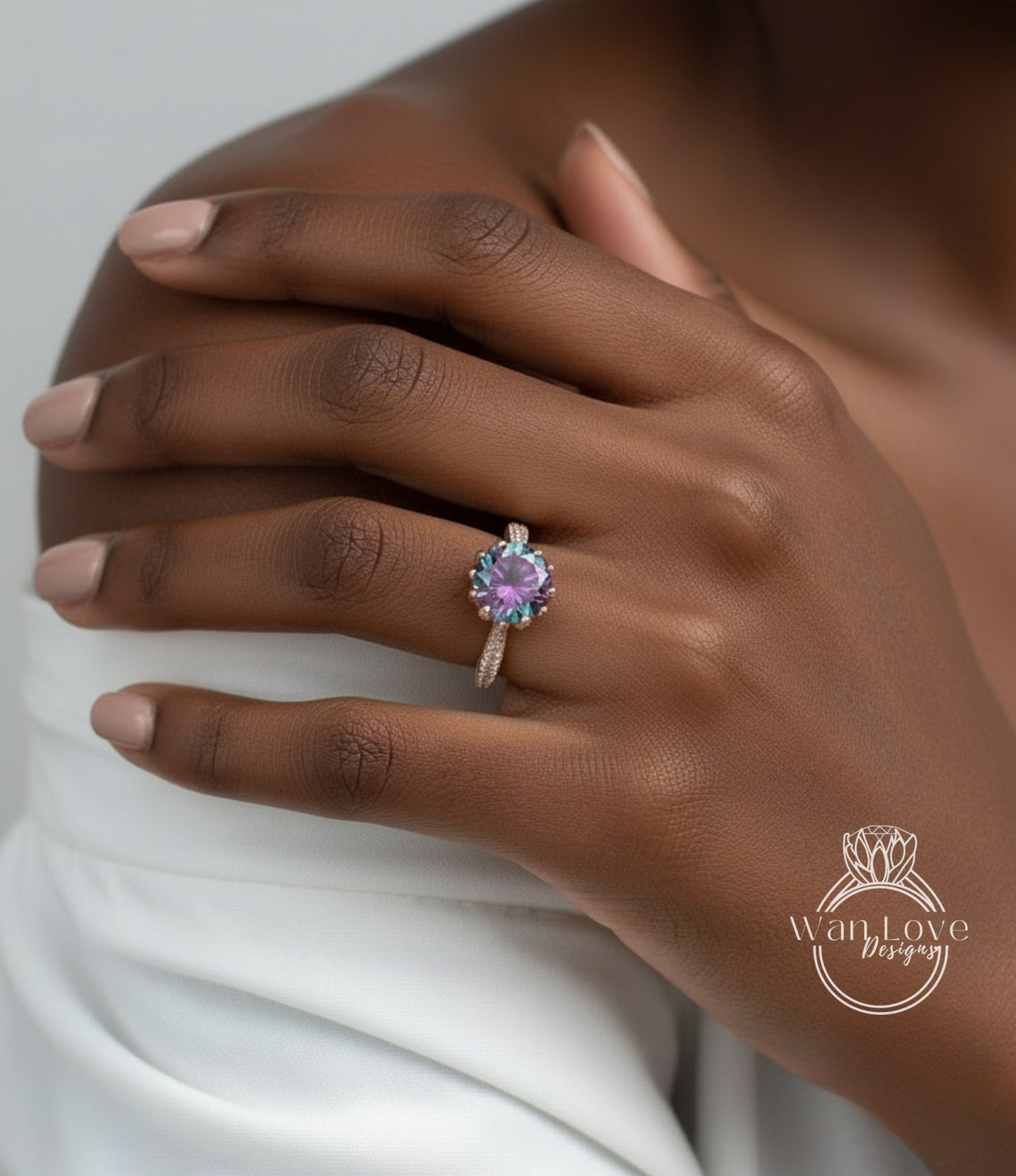 A close-up of a person's hand wearing a ring with a purple gemstone.