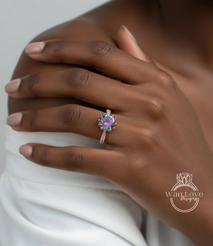 A close-up of a person's hand wearing a ring with a purple gemstone.