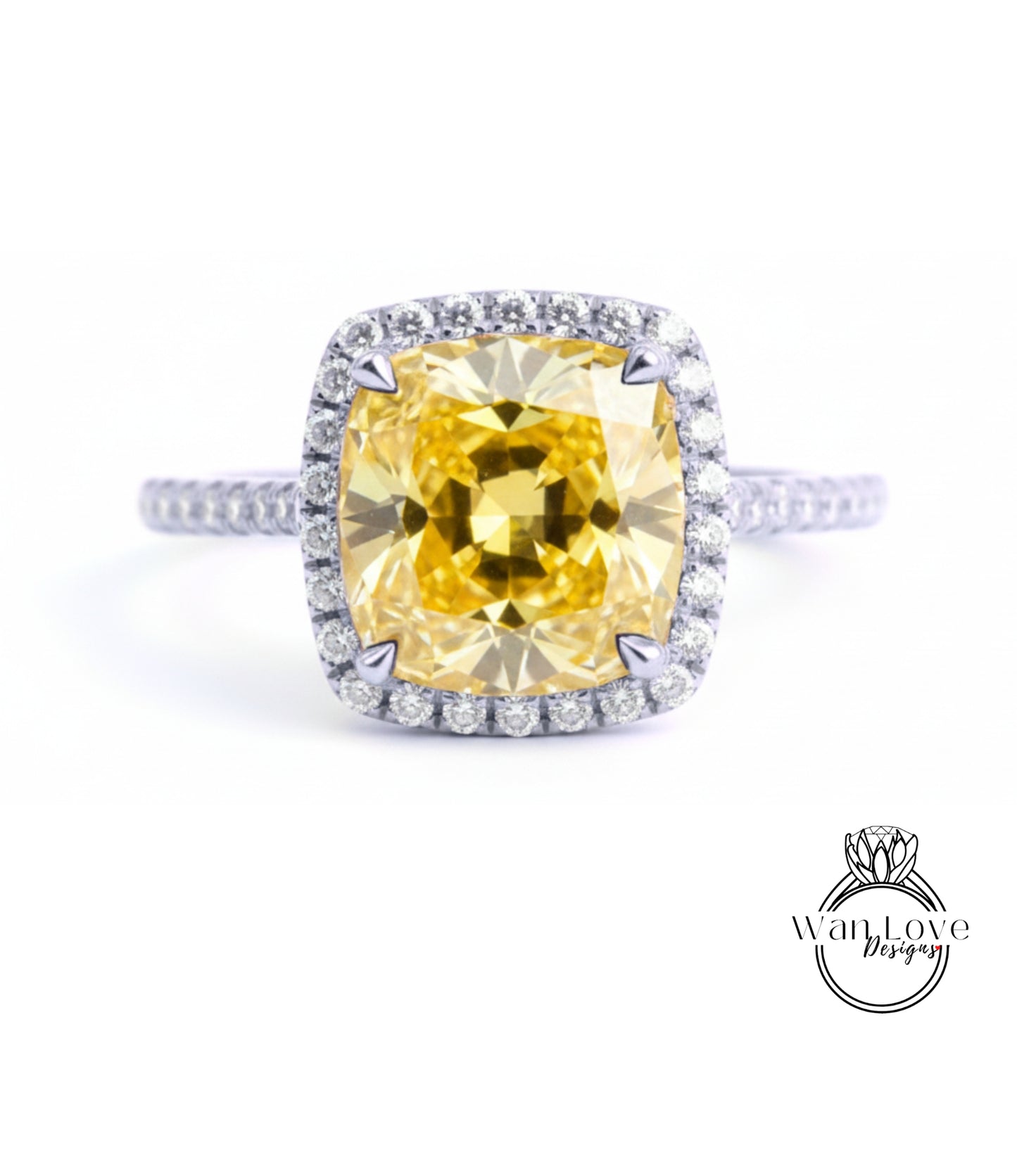 A large yellow diamond ring with a halo of smaller diamonds around the center stone.
