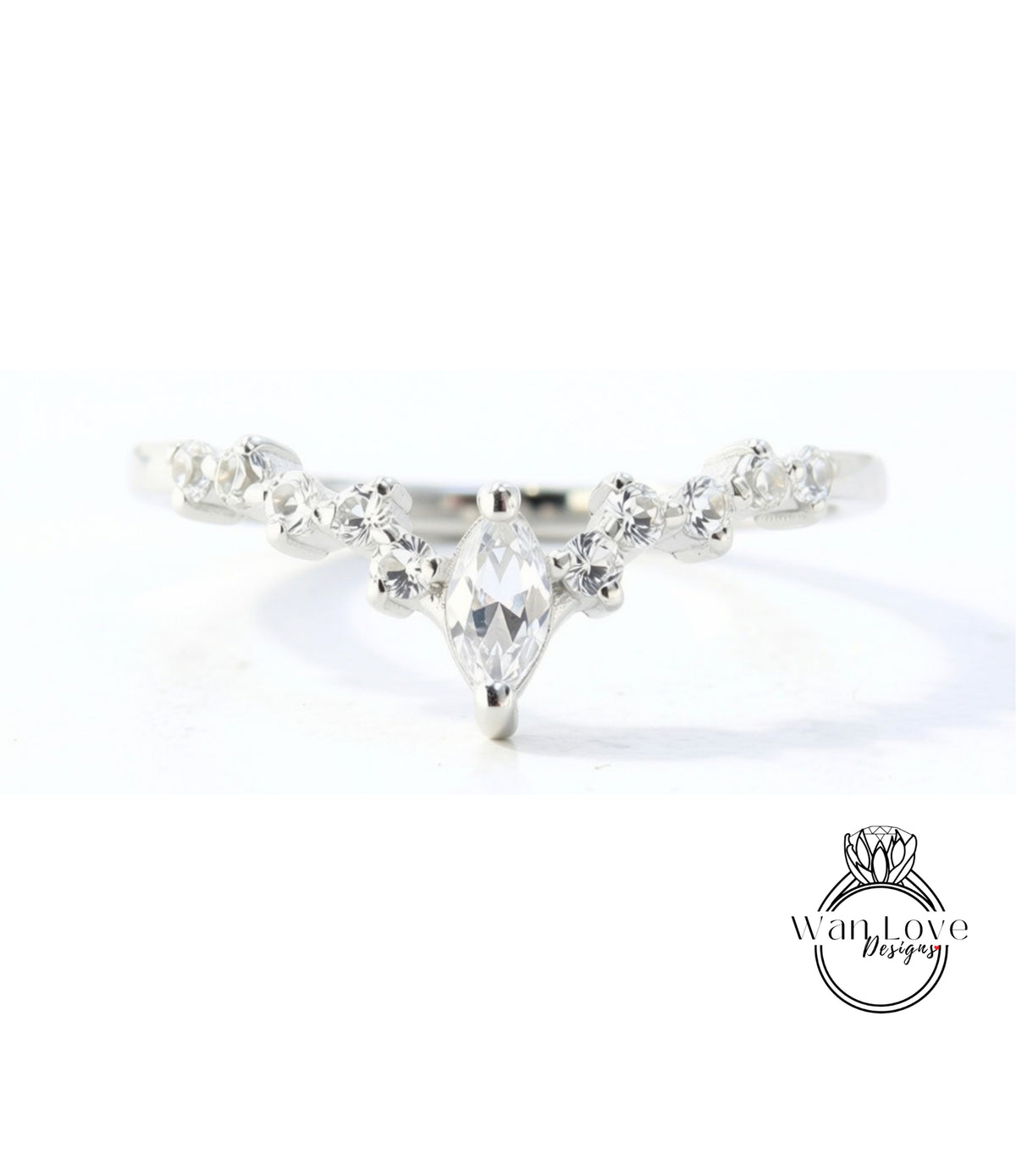 A close-up view of a silver ring with a large central diamond surrounded by smaller diamonds.