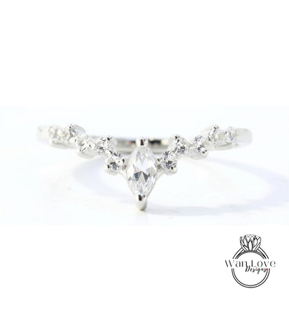 A close-up view of a silver ring with a large central diamond surrounded by smaller diamonds.