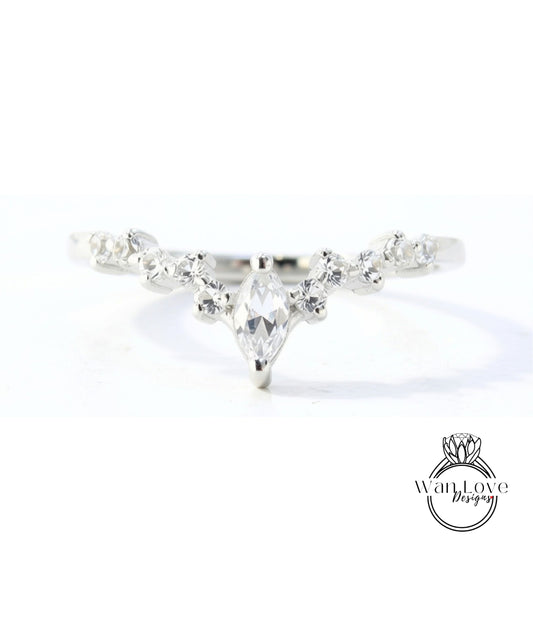 A close-up view of a silver ring with a large central diamond surrounded by smaller diamonds.