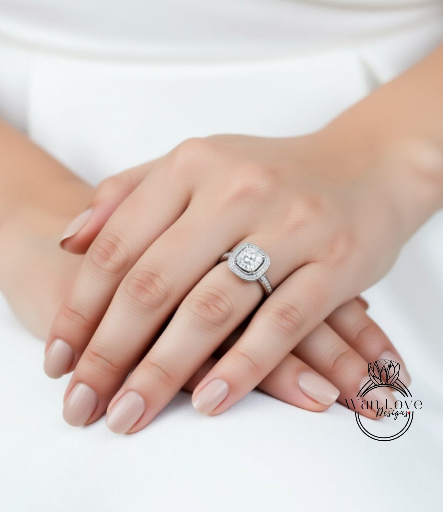 A close-up of a person's hands wearing a diamond engagement ring.