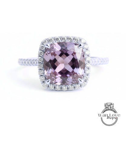 A stunning ring featuring a large, purple gemstone surrounded by a halo of diamonds.