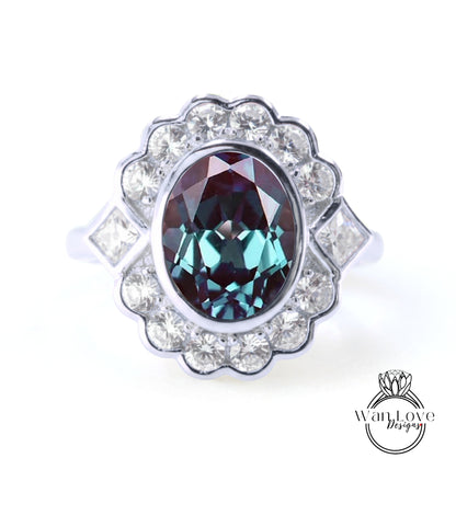 A silver ring with a large oval-shaped gemstone at the center, surrounded by smaller diamonds.