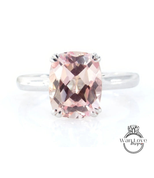 A ring with a large, pink gemstone set in a silver band.