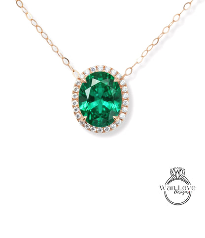 A necklace with a large oval-shaped green gemstone surrounded by smaller diamonds, set in a gold-toned metal.