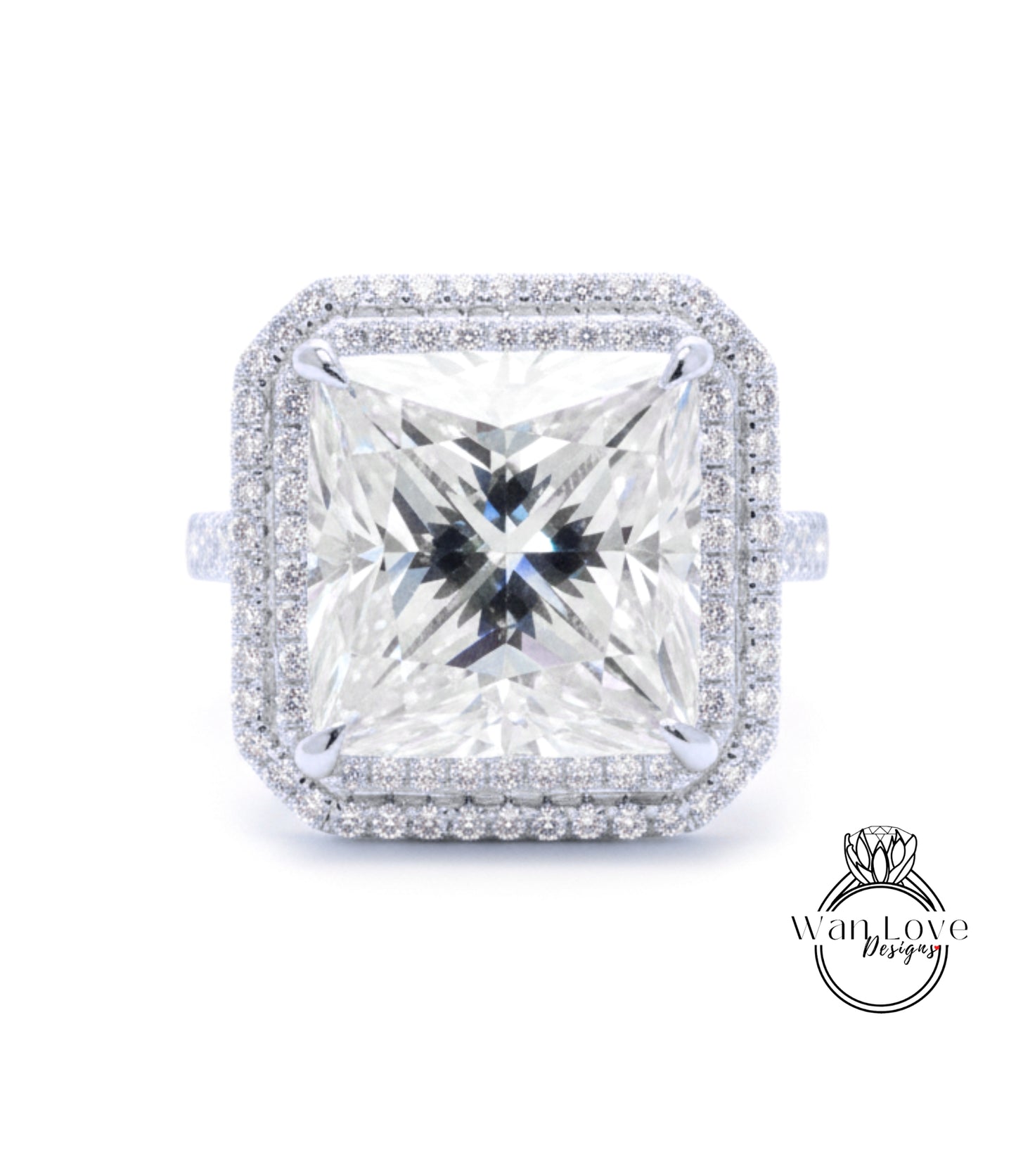 A large, square diamond ring with a halo of smaller diamonds around the edges, set in a silver band.