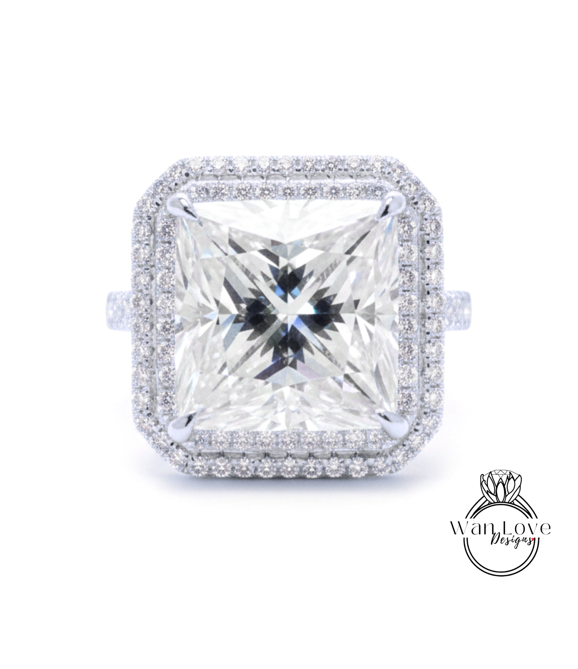 A large, square diamond ring with a halo of smaller diamonds around the edges, set in a silver band.