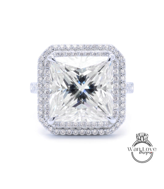 A large, square diamond ring with a halo of smaller diamonds around the edges, set in a silver band.