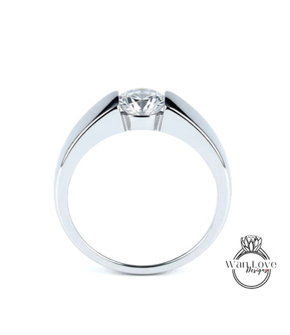A silver ring with a large central diamond.