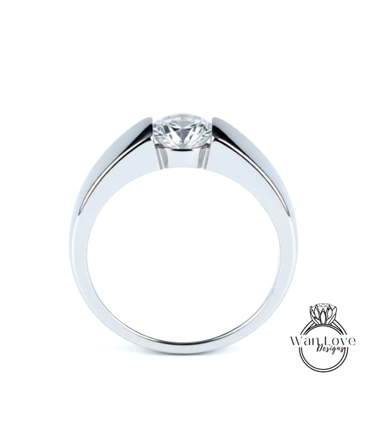 A silver ring with a large central diamond.