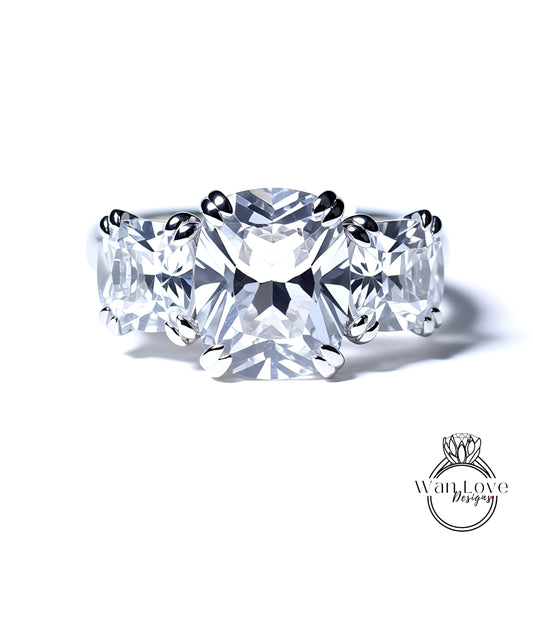 A close-up of a diamond ring with three large, clear diamonds set in a silver band.