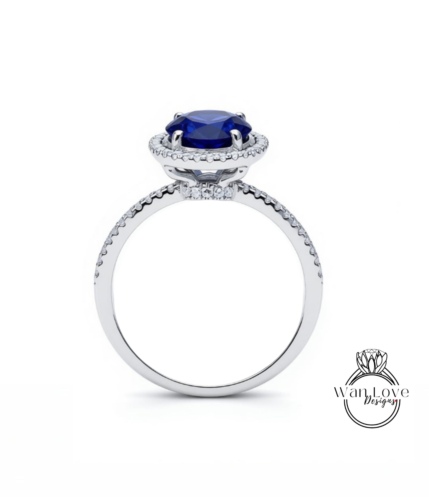 A silver ring with a large blue gemstone, likely a sapphire, at the center.