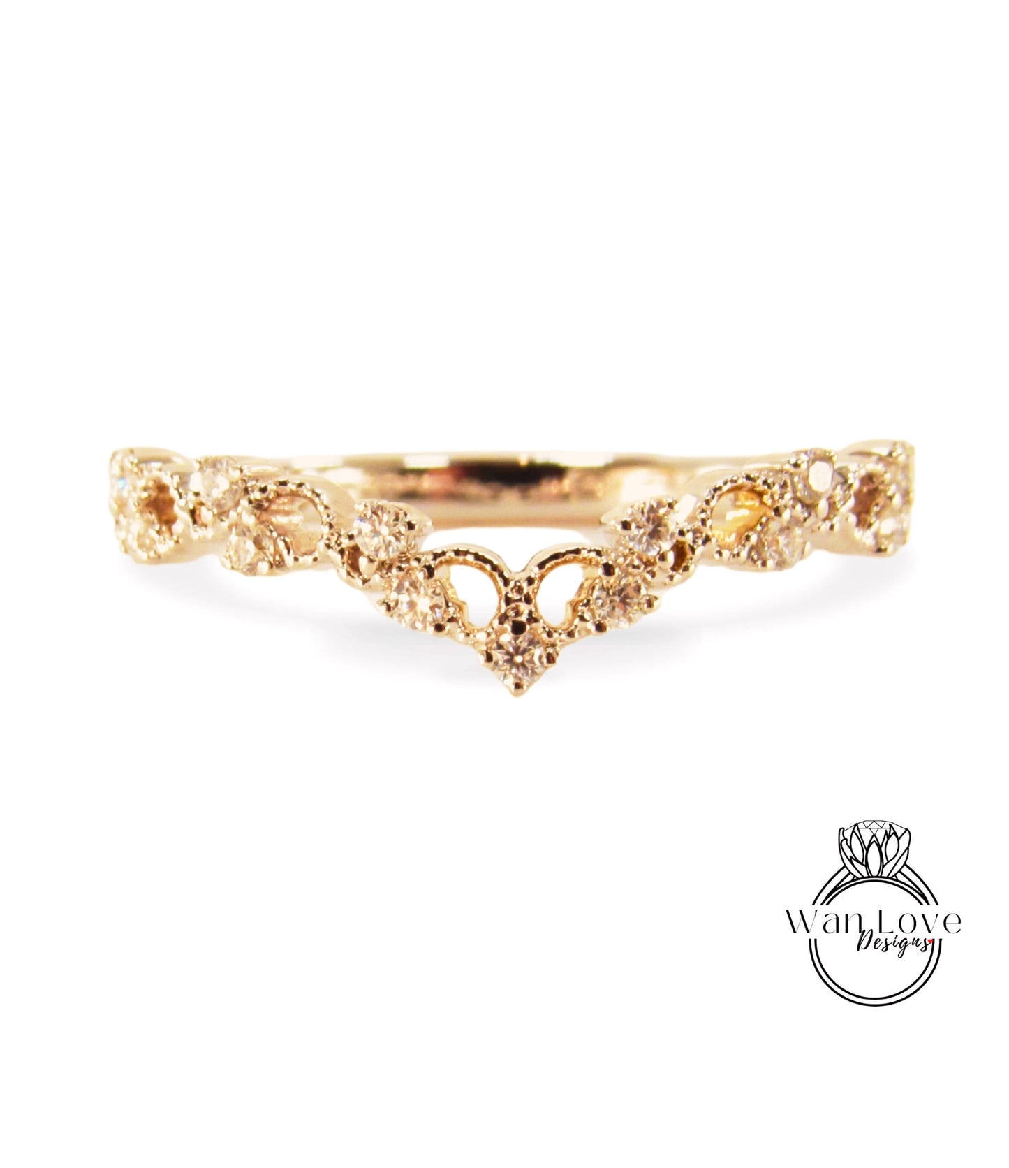 A gold ring with a decorative floral design and small diamonds.