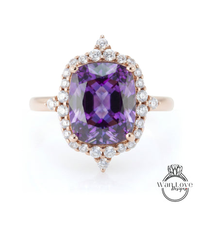 a large, purple gemstone ring with a halo of smaller diamonds around it.