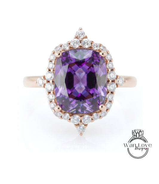 a large, purple gemstone ring with a halo of smaller diamonds around it.