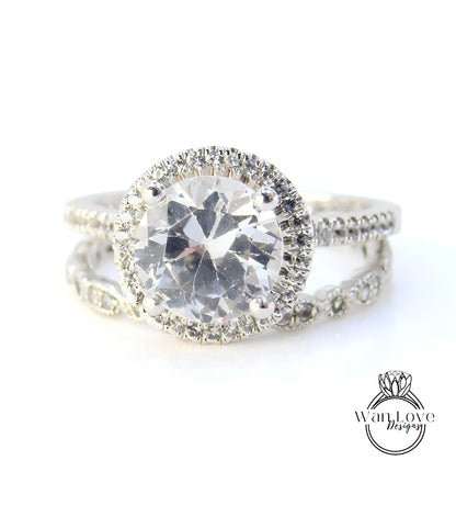 A close-up view of a diamond engagement ring with a large central diamond surrounded by smaller diamonds on the band.