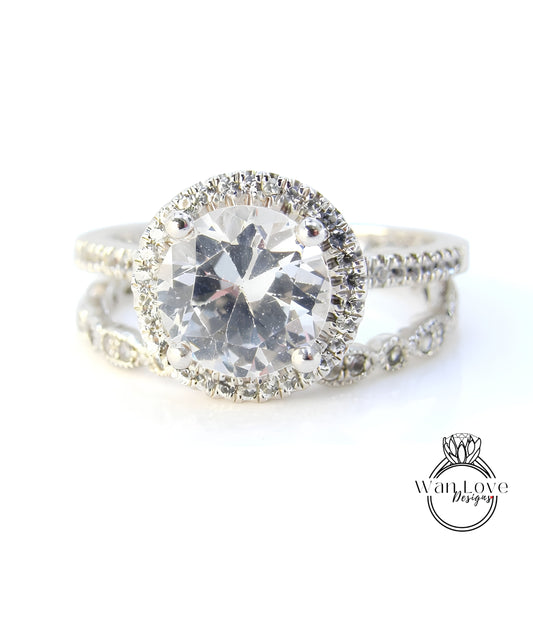A close-up view of a diamond engagement ring with a large central diamond surrounded by smaller diamonds on the band.