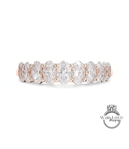 A row of oval-shaped diamonds set in a gold band.