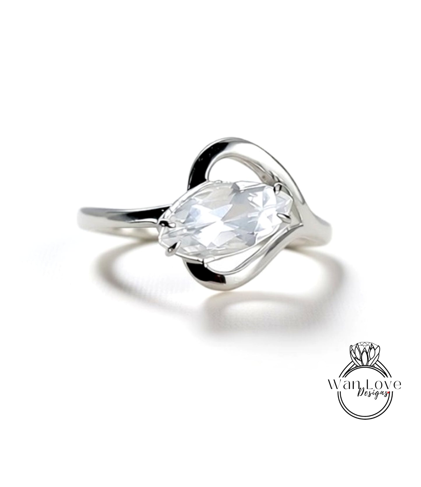 A close-up view of a silver ring with a large, clear gemstone set in the center.
