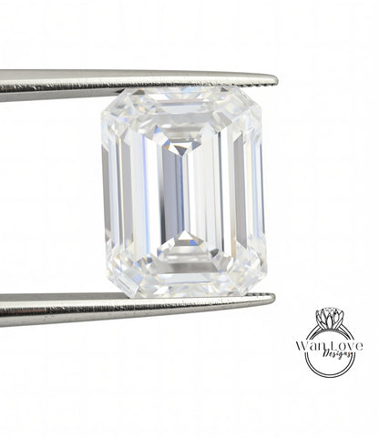 A large, clear diamond is being held between two metal tongs, showcasing its brilliant cut and sparkling clarity.