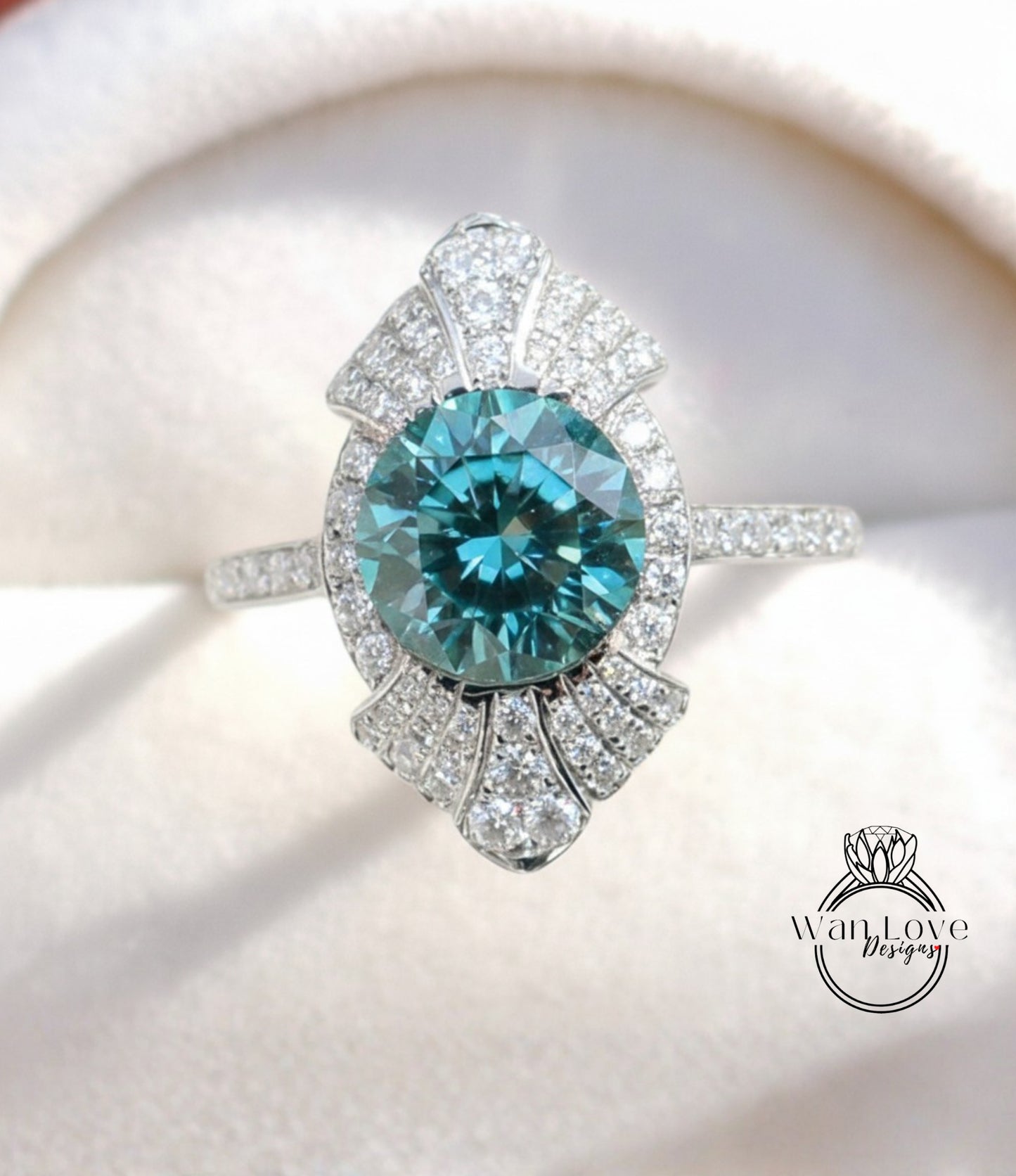 A close-up image of a diamond ring with a large, blue gemstone surrounded by smaller diamonds.