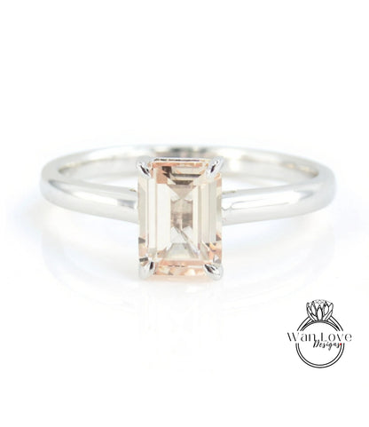 A silver ring with a large, rectangular-shaped gemstone in the center.