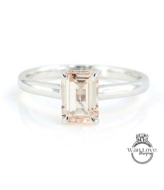 A silver ring with a large, rectangular-shaped gemstone in the center.