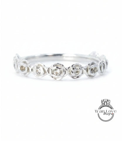 A silver ring with a row of small, round diamonds set in the center.