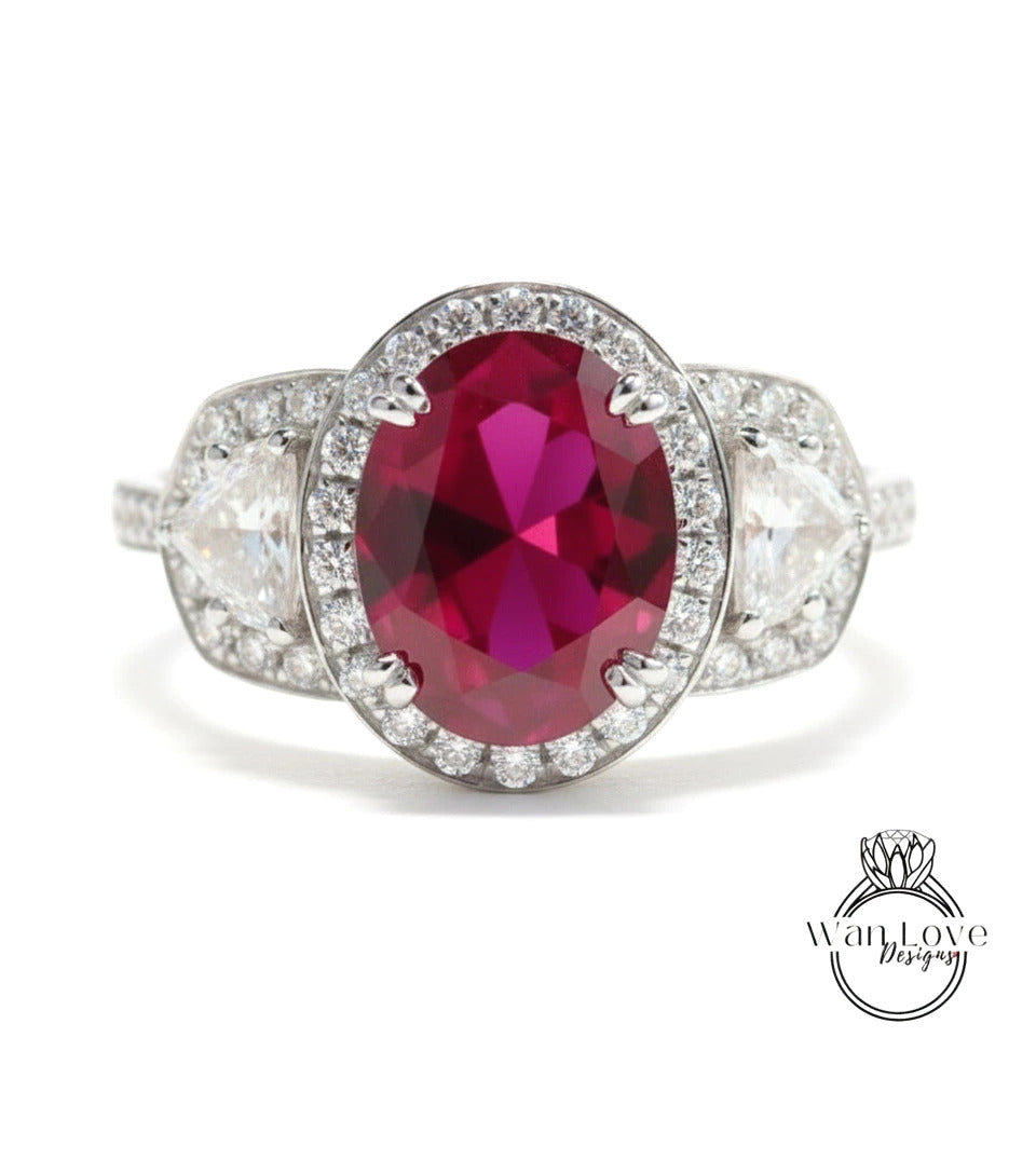A stunning ring featuring a large oval-shaped red gemstone surrounded by a halo of smaller diamonds, set in a silver band.