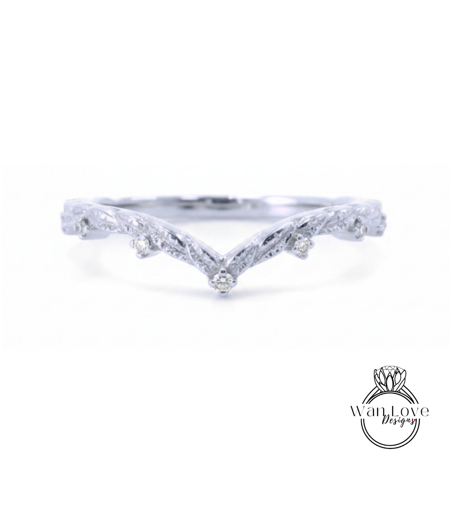 A silver ring with a v-shaped design and small diamonds set in the center.