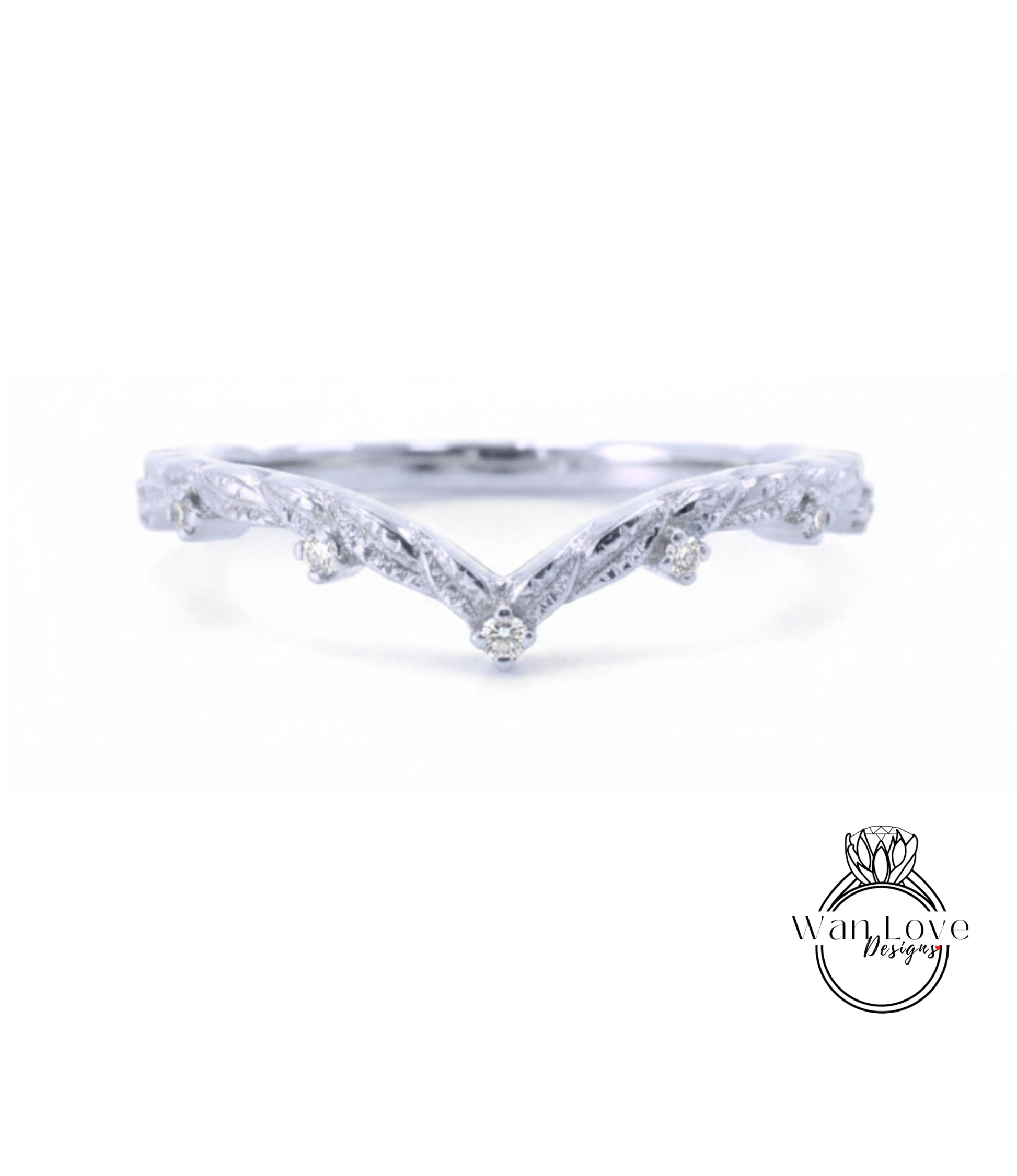 A silver ring with a v-shaped design and small diamonds set in the center.