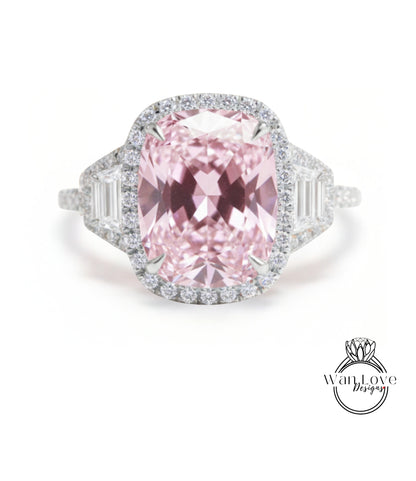 A stunning pink diamond ring with a large central gemstone surrounded by smaller diamonds set in a halo of smaller diamonds.