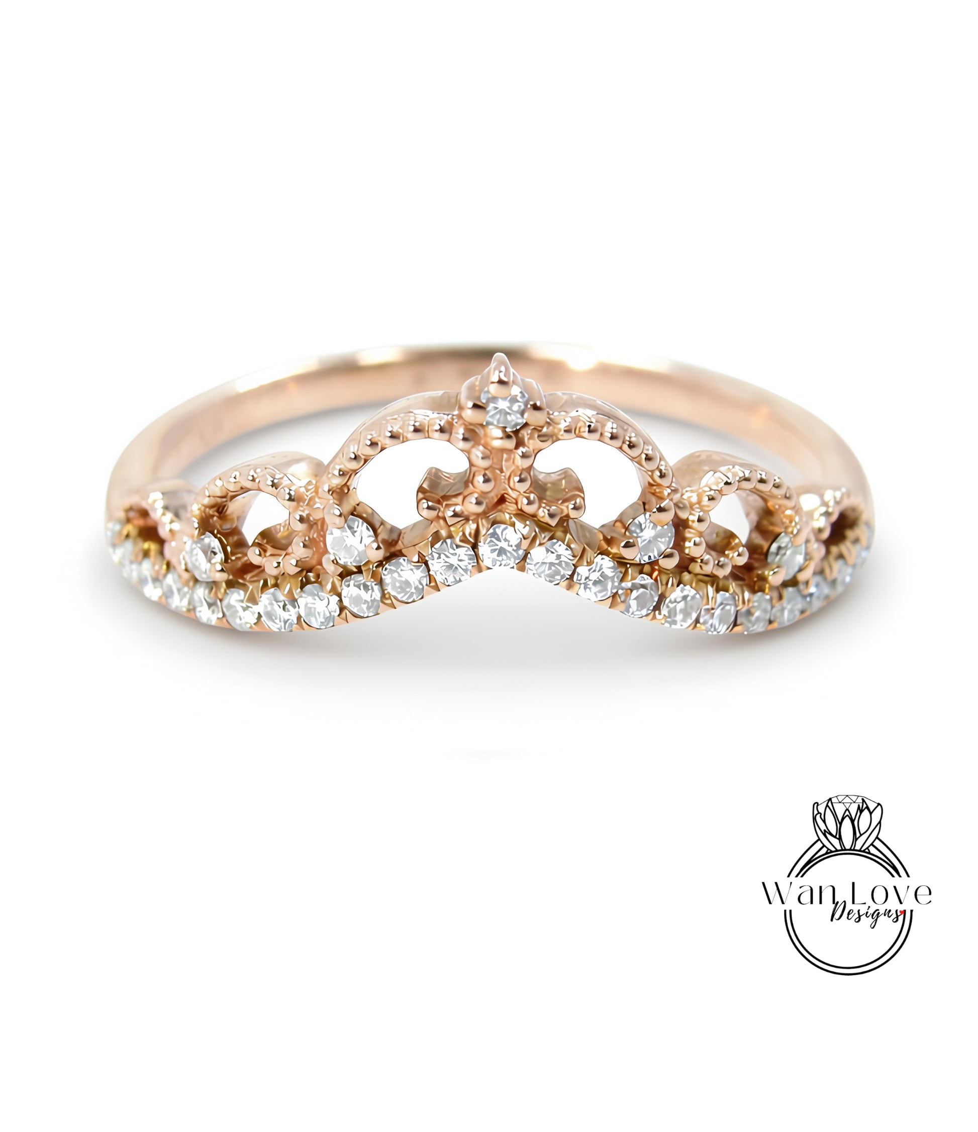 A gold ring with a decorative crown-like design and sparkling diamonds.
