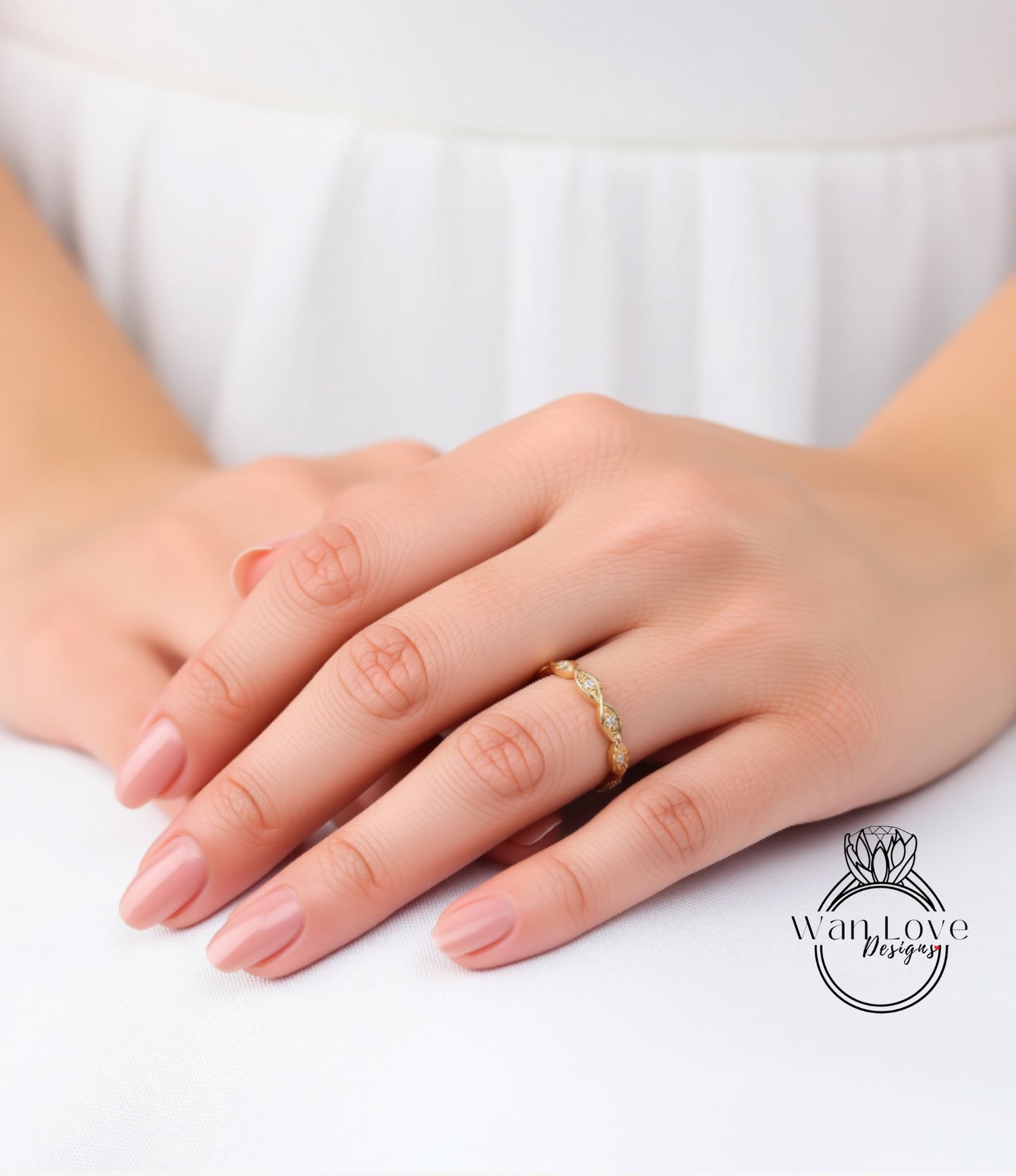 A close-up of a person's hands wearing a gold ring on the ring finger.