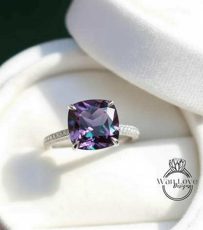 A close-up image of a silver ring with a large, purple gemstone set in the center.