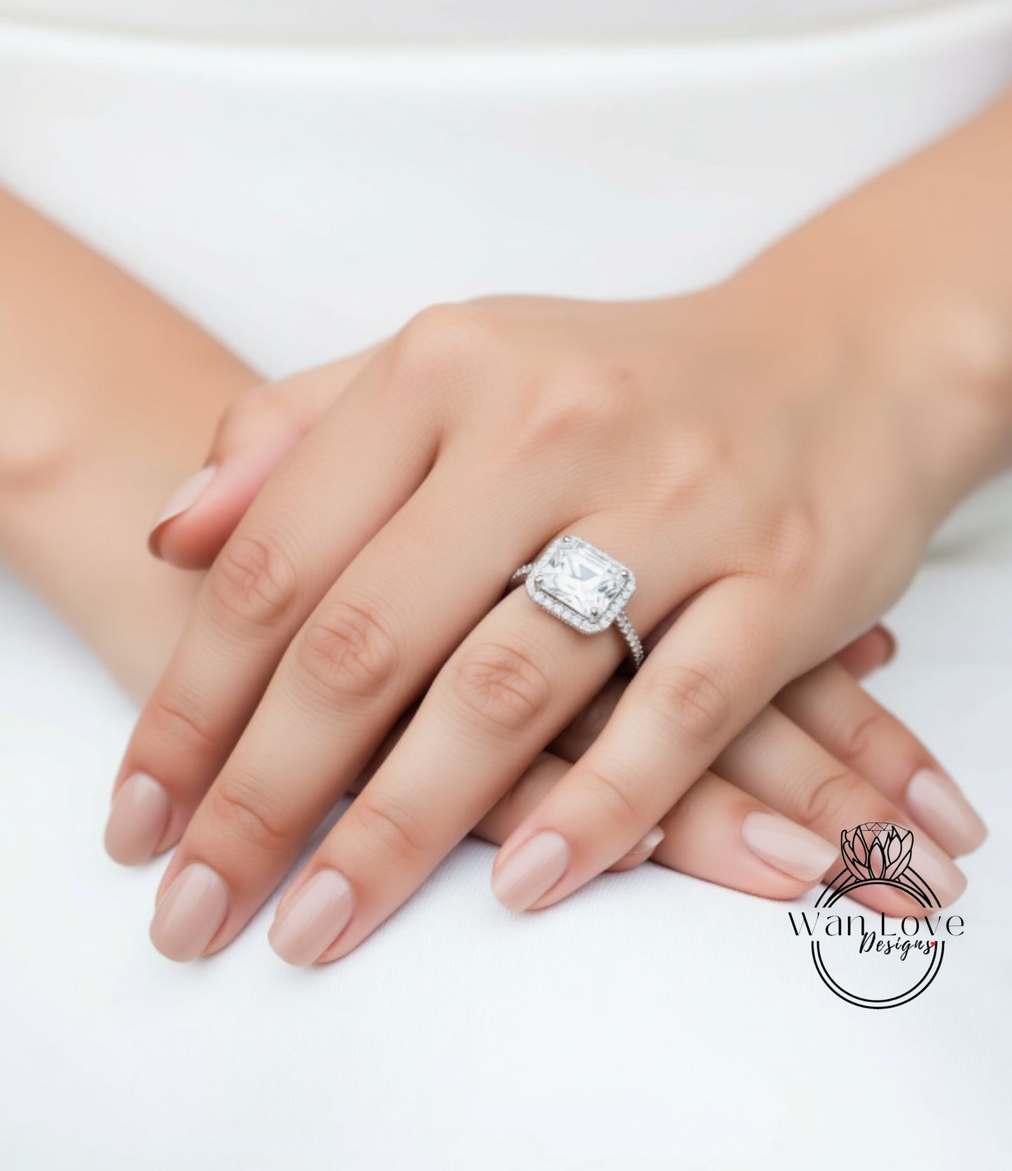 A close-up of a person's hand wearing a large diamond engagement ring.