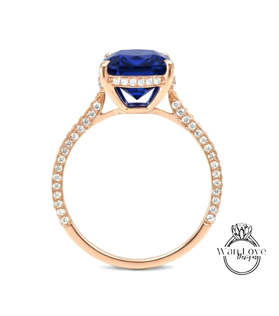A gold ring with a large blue gemstone, likely a sapphire, set in a rose gold band.
