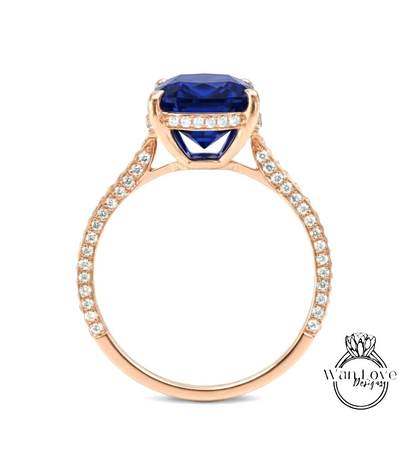 A gold ring with a large blue gemstone, likely a sapphire, set in a rose gold band.