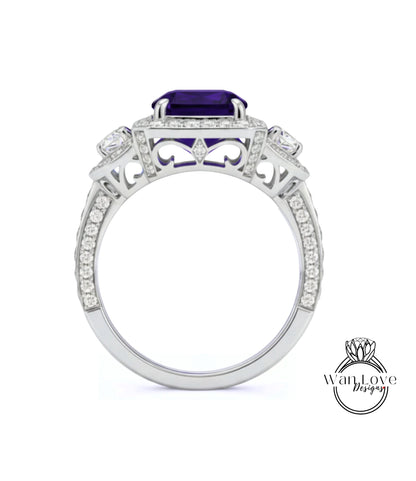 A silver ring with a large purple gemstone, surrounded by smaller diamonds and intricate designs.