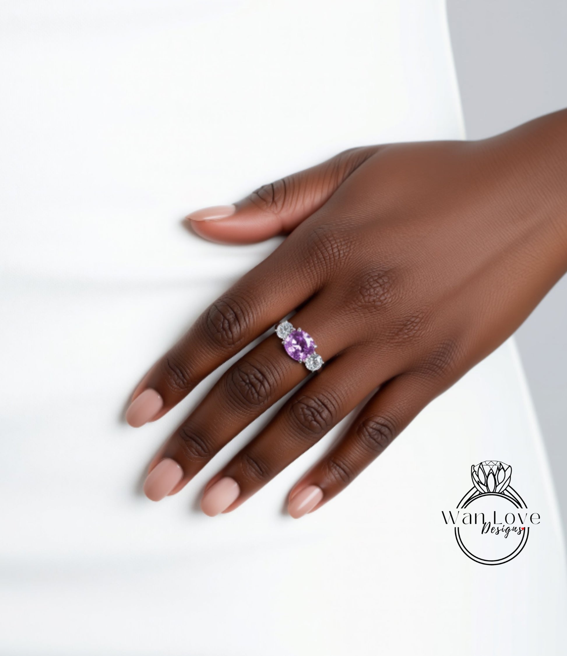 A close-up of a hand wearing a ring with a purple gemstone.