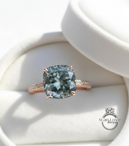 A large, square-cut green gemstone, possibly a type of aquamarine, set in a rose gold ring with a thin gold band and small diamonds.