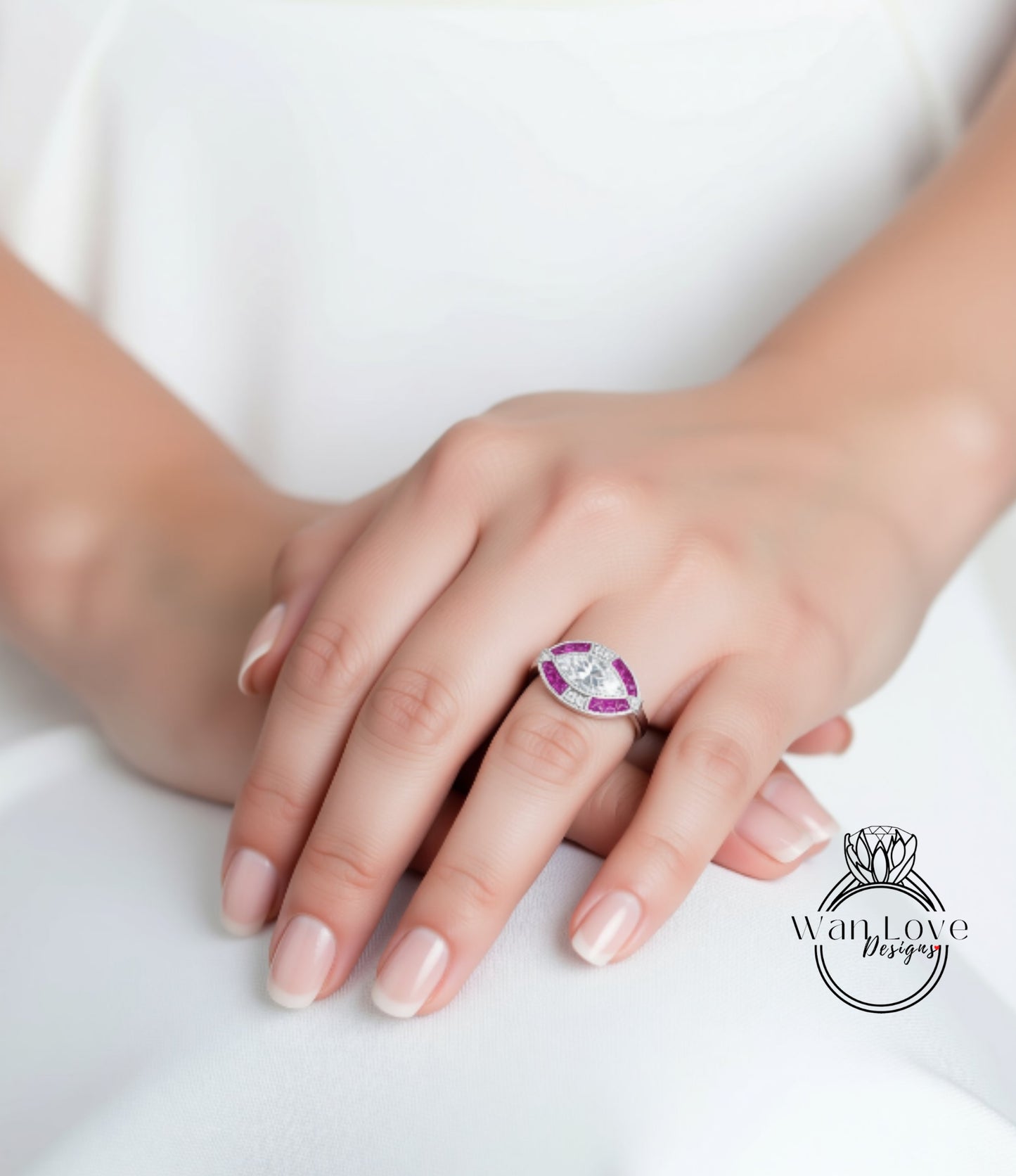 A close-up of a person's hand wearing a ring with a large central gemstone surrounded by smaller stones.