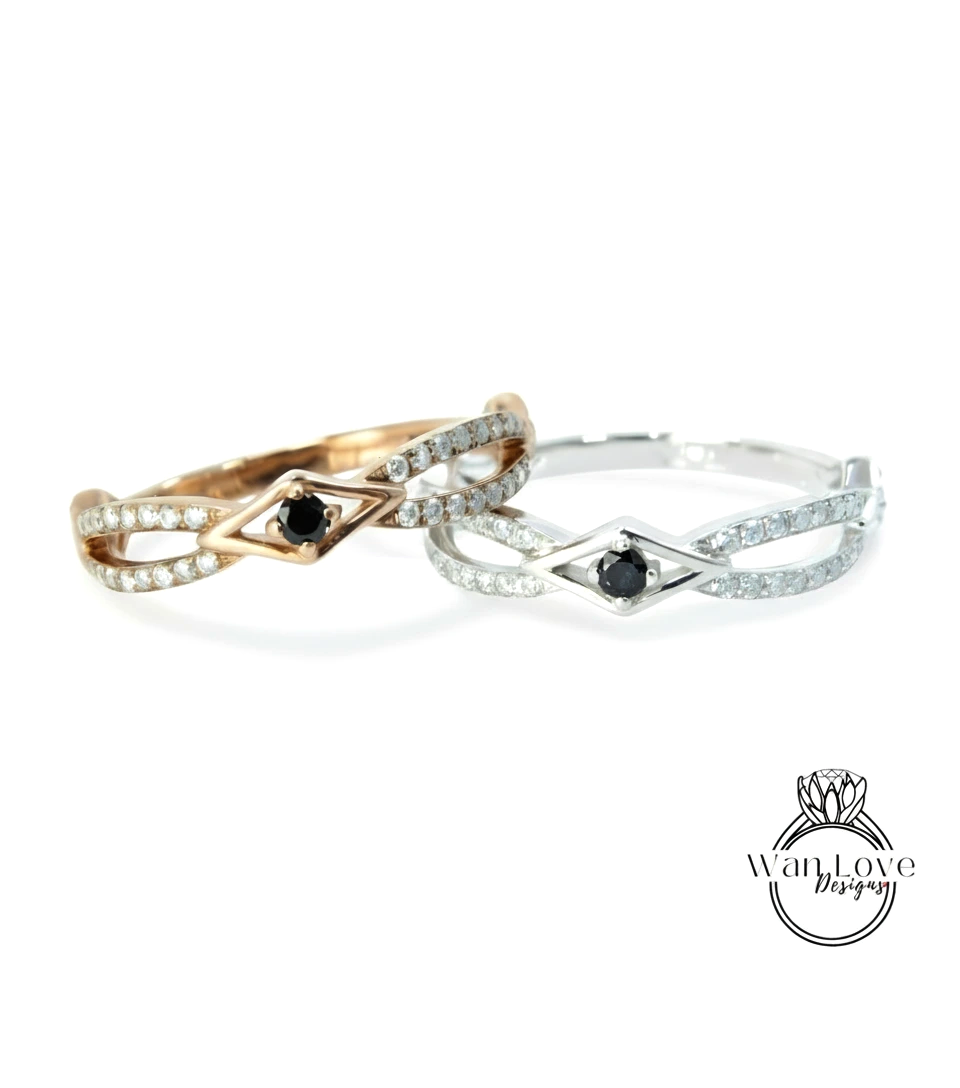 Two rings with diamonds and a black gemstone are displayed against a white background.