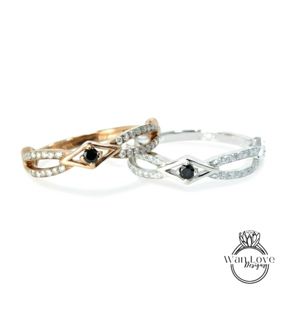 Two rings with diamonds and a black gemstone are displayed against a white background.