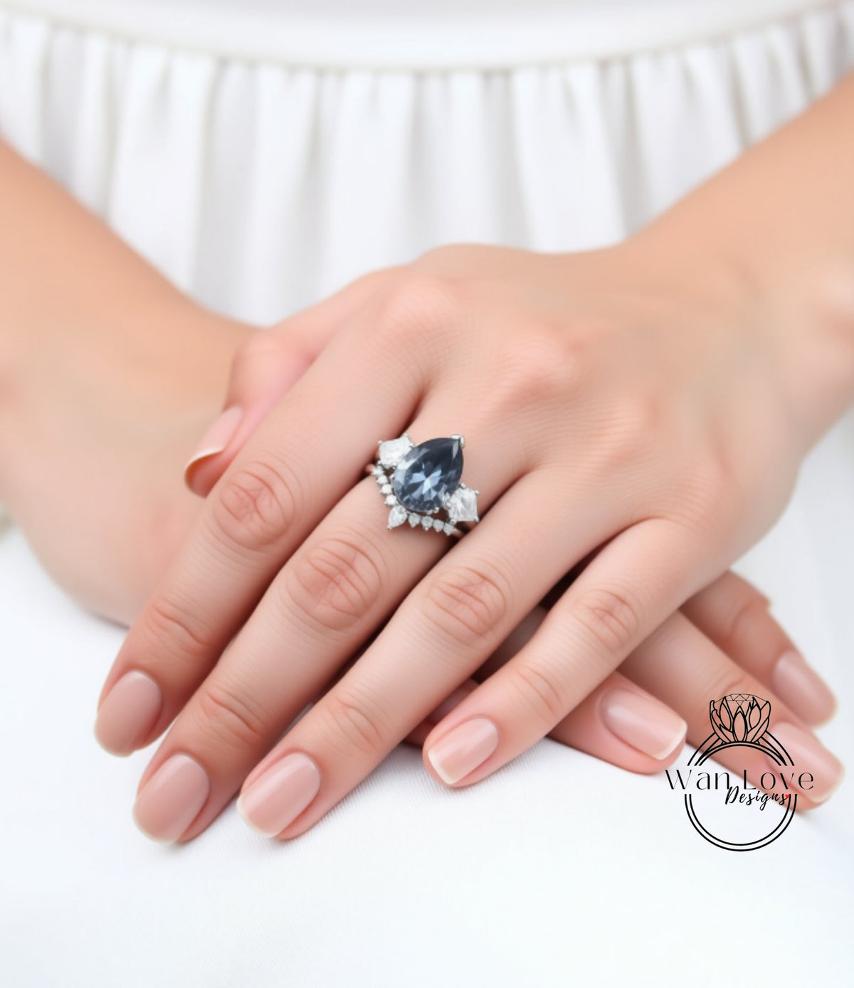 A close-up of a person's hand wearing a large, ornate ring with a blue gemstone.