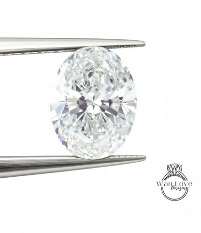 A large, clear diamond is being held between two metal tweezers, with the tweezers positioned on either side of the diamond.