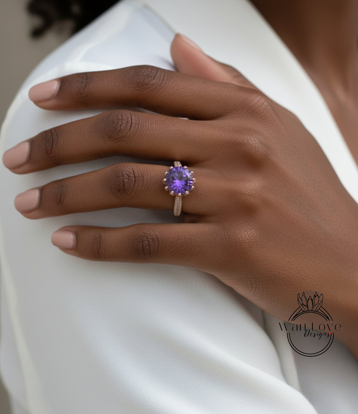 A close-up of a person's hand wearing a ring with a purple gemstone.